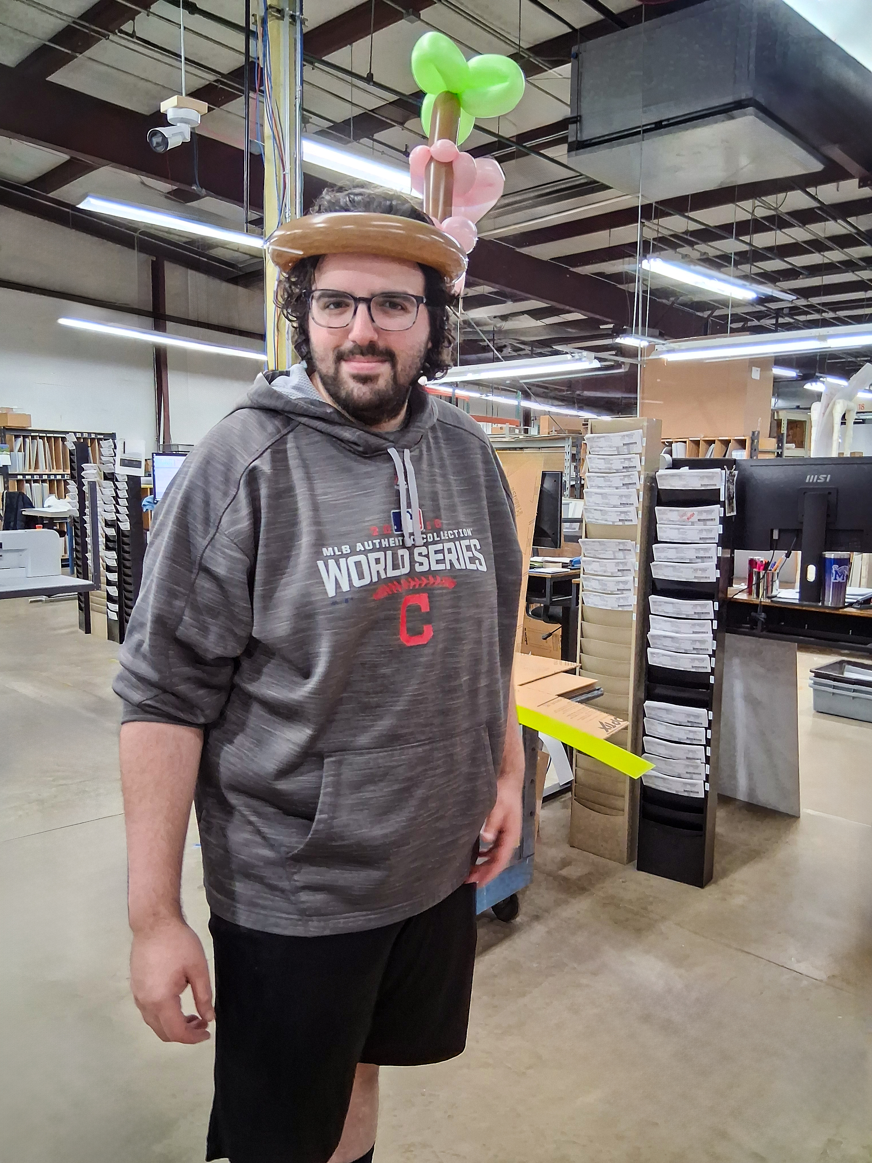 Cody Bennett sporting a fun green balloon animal hat made during our appreciation week.