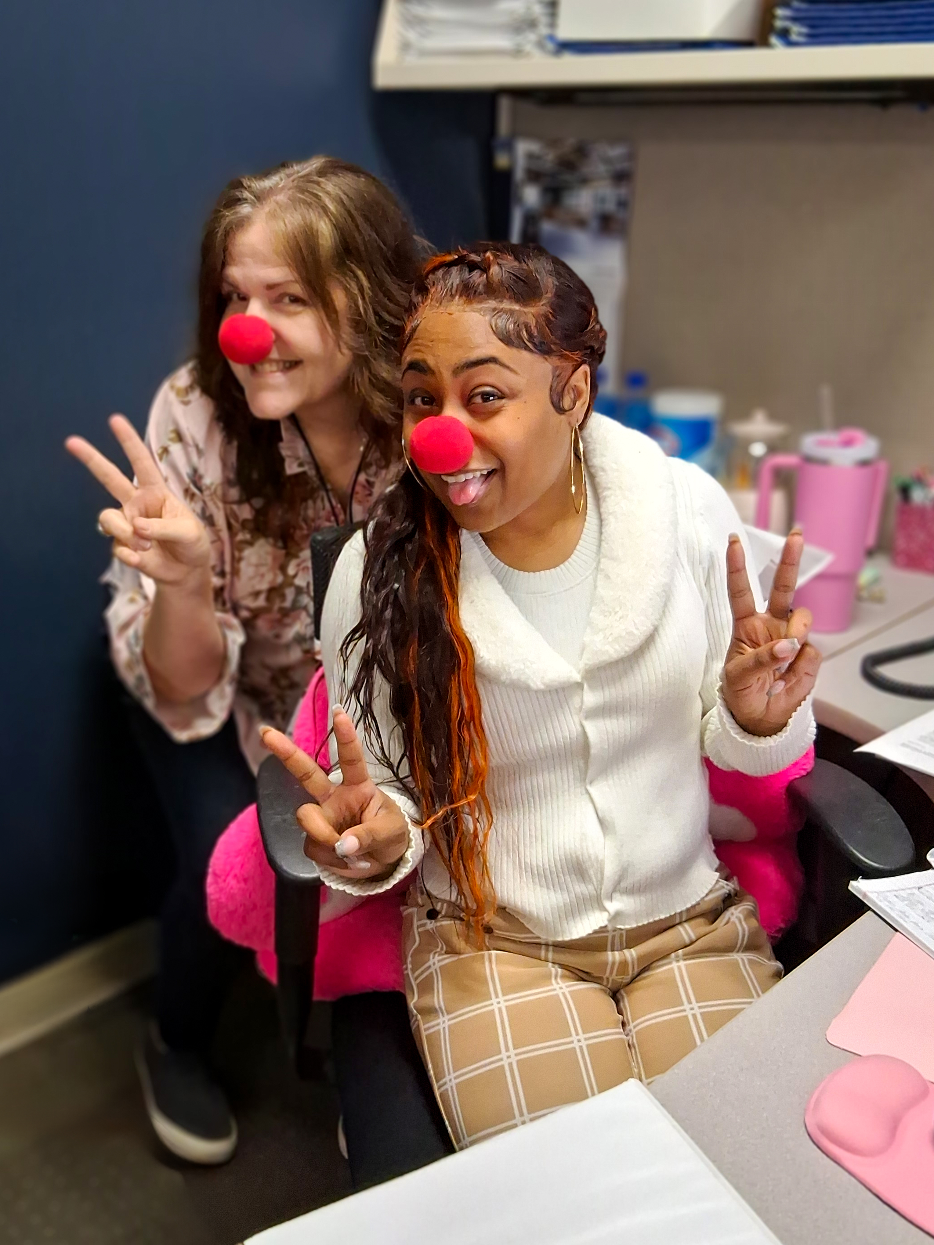 Patty and Shaughnessy share a laugh wearing red clown noses, kicking off our Bigtop Tribute employee appreciation week.