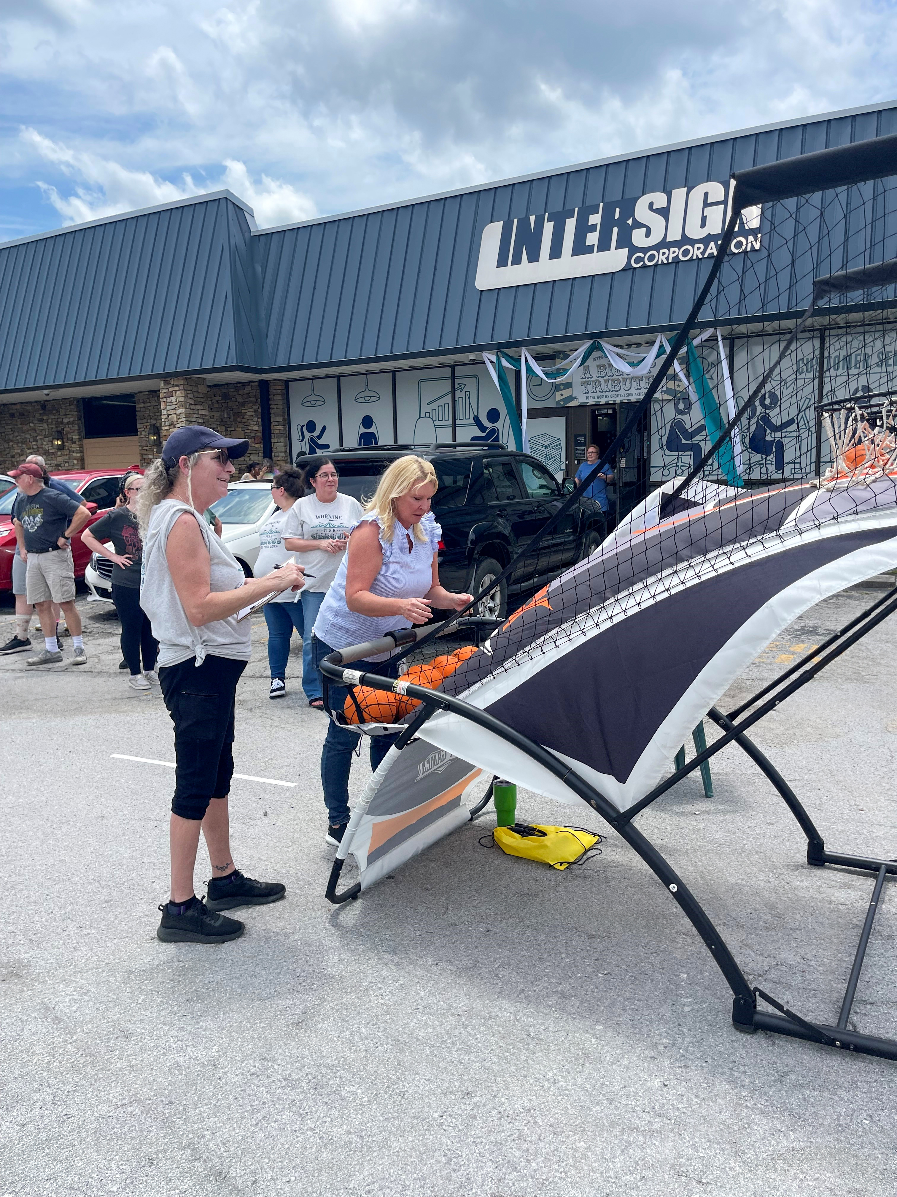 Liz Allen and Laurie enjoy friendly competition at the basketball toss during our outdoor appreciation festivities.