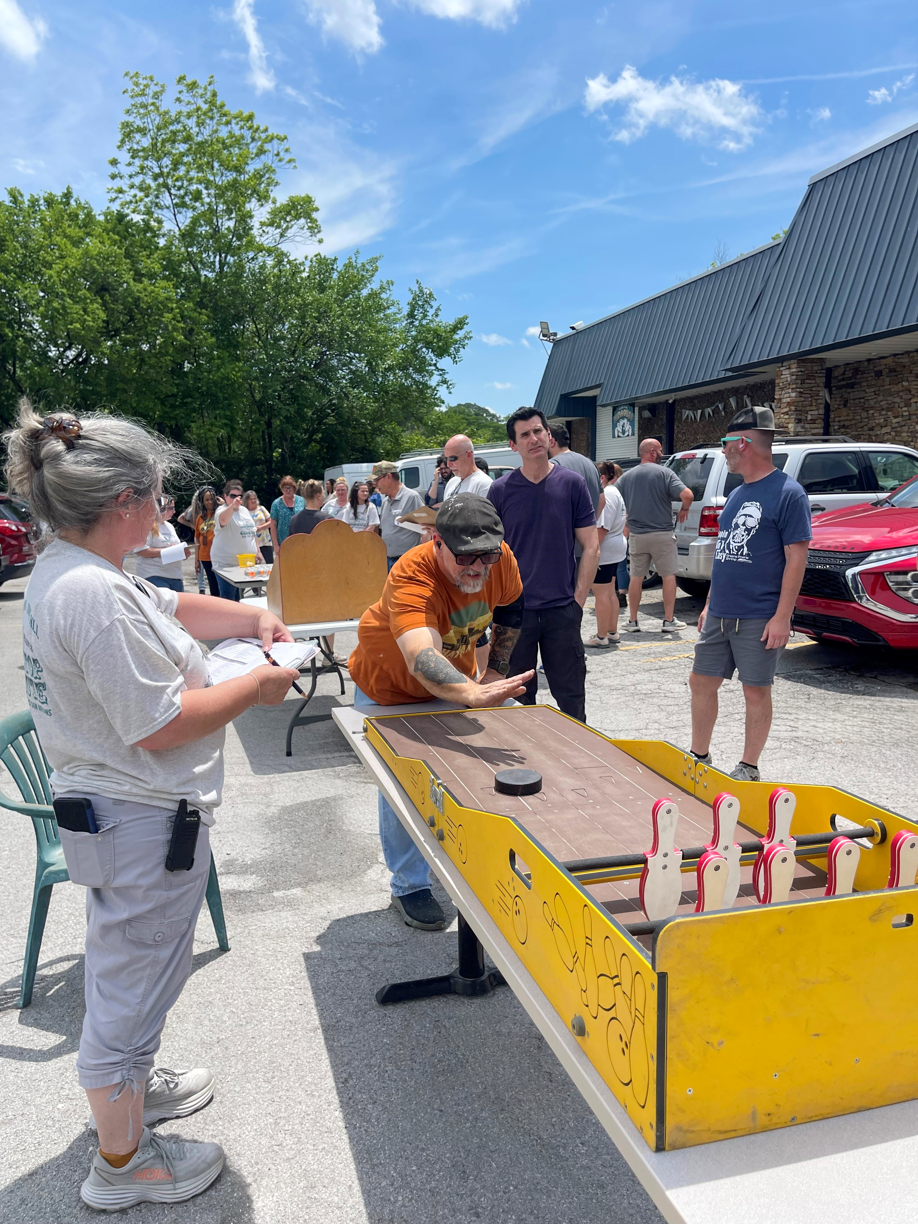 Tom Foster immersed in the fun of midway games, contributing to the lively atmosphere of our appreciation week.