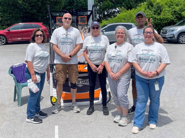 The Employee Appreciation Week Planning Committee, all sporting their "Warning: It's a Circus Here This Week" shirts.