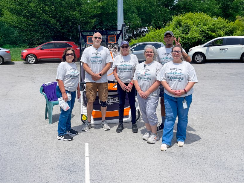 The Employee Appreciation Week Planning Committee, all sporting their "Warning: It's a Circus Here This Week" shirts.