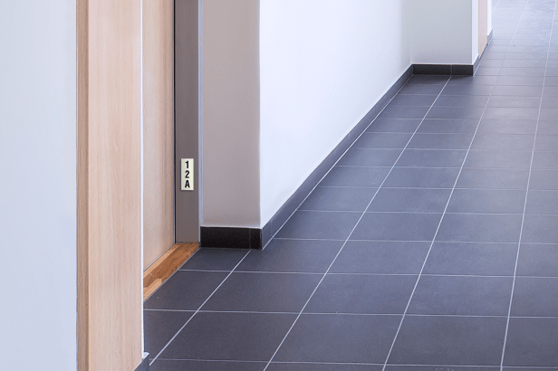 Photoluminescent Room No. - Single Level Unit - NYC sign mounted low on wall identifying room location.